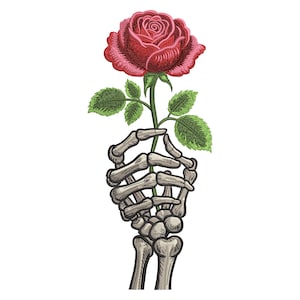 May include: An embroidered design featuring a red rose held by a skeletal hand. The rose has detailed petals and is surrounded by green leaves. The hand is intricately detailed, with visible bone structure, set against a white background.