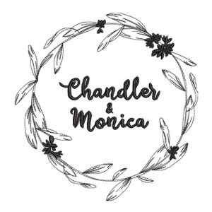May include: A black and white embroidery design featuring a circular wreath of sketched leaves and small flowers. The text Chandler & Monica is centered within the wreath in a bold, cursive script font. The entire graphic is rendered in black.
