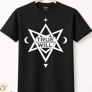 May include: Black t-shirt with a white geometric design. The design includes the text "TRUE WILL", a star, crescent moons, and a downward-pointing triangle. Made from premium cotton.