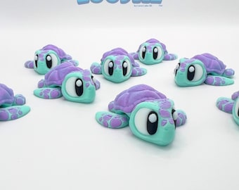 May include: A collection of colorful turtle figurines. Each turtle has a purple shell, a light blue body, and large white eyes with black pupils. The image includes the text "Zoodlez" in blue.
