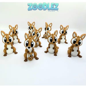 May include: A collection of brown kangaroo figurines with white bellies and large, expressive eyes. Some kangaroos have a baby in their pouch. The text "ZOOODLEZ" is displayed in blue above the figurines.