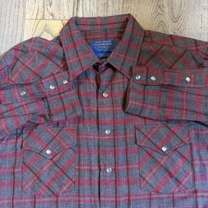 May include: A white ceramic mug with a black handle and the text "But First, Coffee" in a handwritten style. The mug is on a white surface. The mug is approximately 4 inches tall.