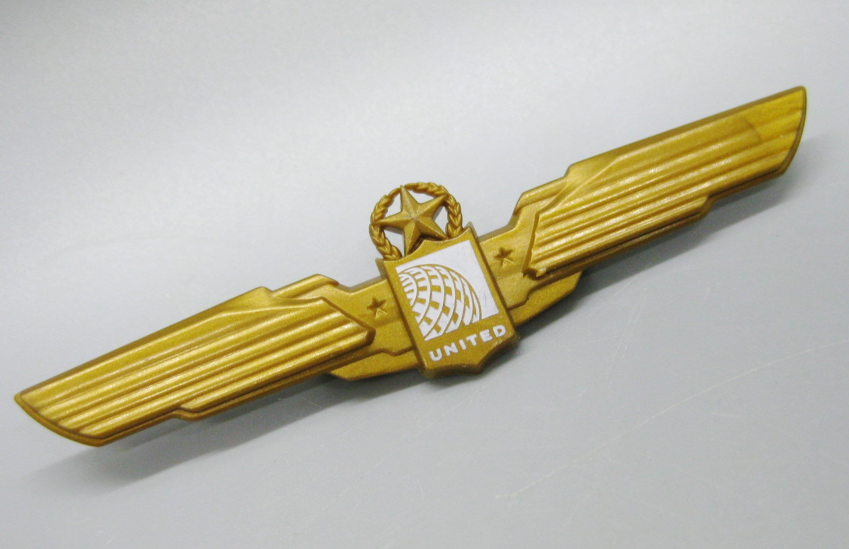 Vintage United Airlines Gold Plastic Wings Badge Flight Souvenir