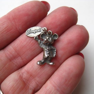 May include: A white ceramic mug with a black handle and the text "But First, Coffee" in a bold, black font. The mug is set against a blurred background, suggesting a cozy setting.