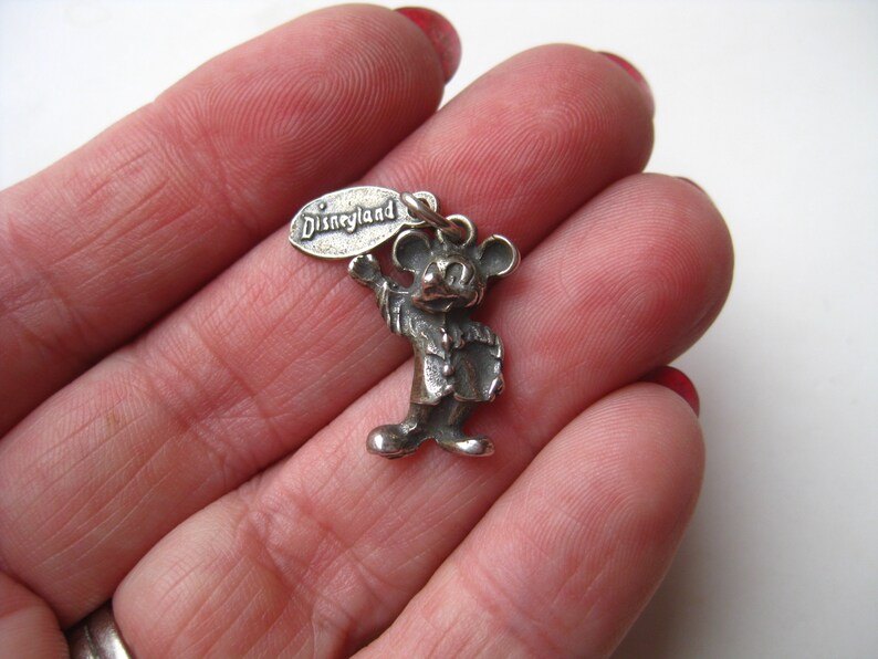 May include: A white ceramic mug with a black handle and the text "But First, Coffee" in a bold, black font. The mug is set against a blurred background, suggesting a cozy setting.