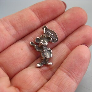 May include: A handmade wooden sign with the text "Welcome" in a playful font. The sign features a distressed white background and a dark stained wooden frame. A decorative floral element is in the corner.