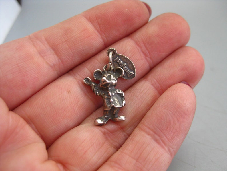 May include: A handmade wooden sign with the text "Welcome" in a playful font. The sign features a distressed white background and a dark stained wooden frame. A decorative floral element is in the corner.