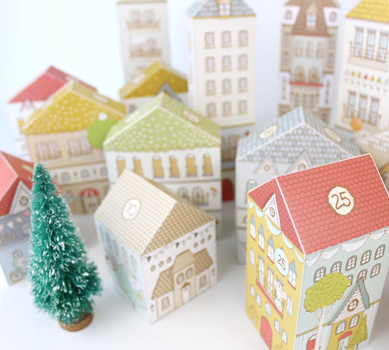 25 uniquely designed paper houses with numbers on the roofs for counting down to Christmas