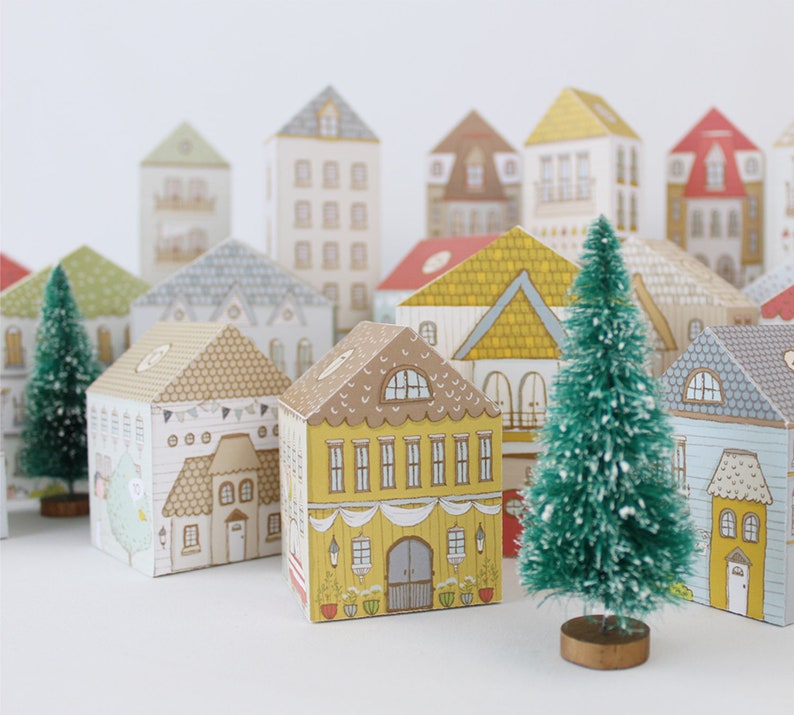 Paper houses with advent calendar treats inside