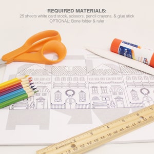 Image shows the materials required to make the advent calendar Christmas coloring houses: white card stock, scissors, glue stick, ruler and bone folder, and pencil crayons
