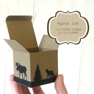 Hand holding a finished advent calendar box to demonstrate it's relative size: 2.25 inches or 5.7 cm cubed