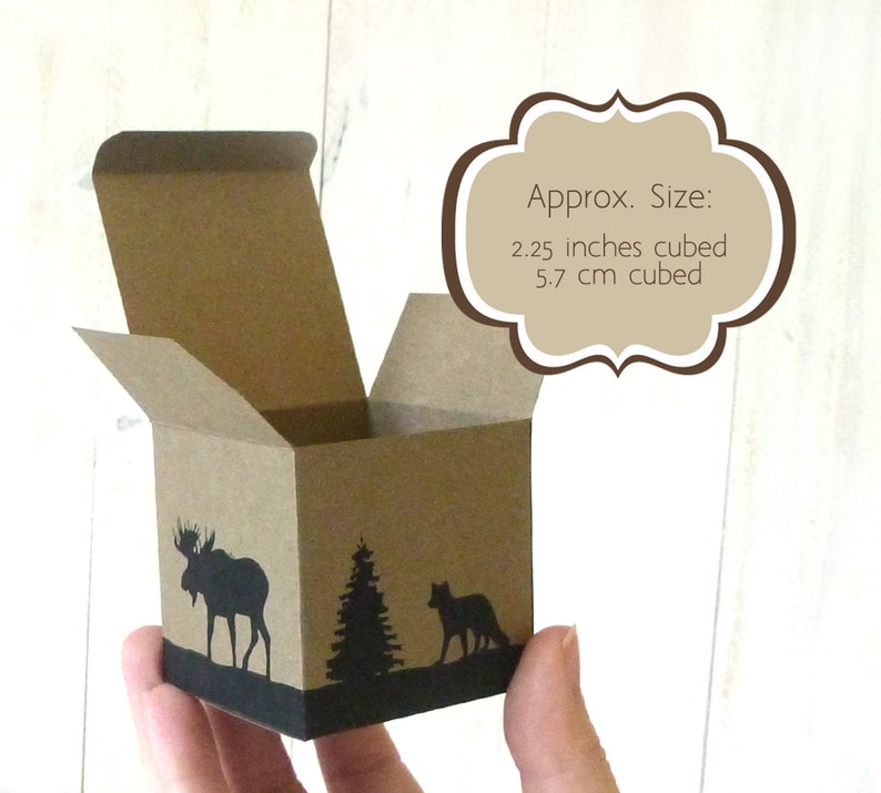 Hand holding a finished advent calendar box to demonstrate it's relative size: 2.25 inches or 5.7 cm cubed