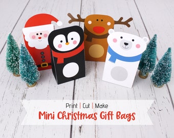 May include: Four printable mini Christmas gift bags featuring Santa, a penguin, a reindeer, and a polar bear. The bags are ready to be printed, cut, and assembled. Print | Cut | Make Mini Christmas Gift Bags.