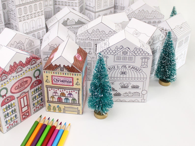 Printable advent calendar set: a couple Christmas houses already coloured next to some not yet coloured