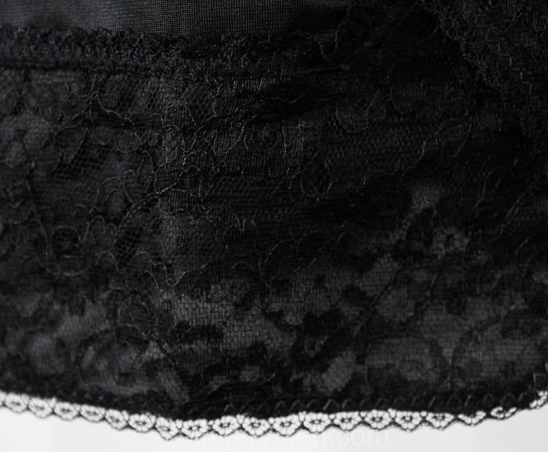 May include: Black lace trim with a white scalloped edge. The lace has a floral pattern.