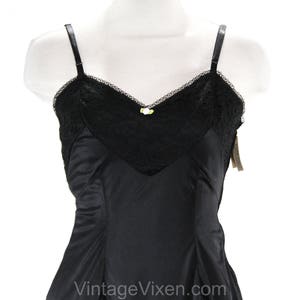 May include: Black lace and satin slip with adjustable straps. The slip has a delicate lace trim and a satin bodice.