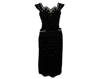 May include: A black velvet dress with a sweetheart neckline and a beaded design. The dress has a fitted bodice and a full skirt.