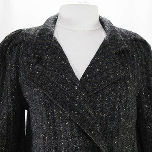 May include: A black and gold tweed blazer with a double-breasted closure and a v-neck collar.