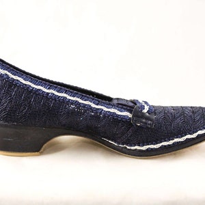 May include: Blue woven fabric shoes with a white trim and a low block heel.