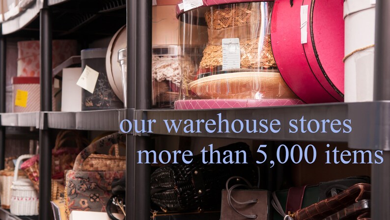 May include: A black metal shelving unit filled with various items, including hats, boxes, and bags. The text "our warehouse stores more than 5,000 items" is visible on the shelf.