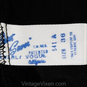 May include: White tag with blue text that reads "Patented Vogue" and "T.M.N.E."  The tag also has the numbers "541 A" and "38" with the word "Size" above the number 38. The tag also has the text "Made in Country of  Reverse Side."