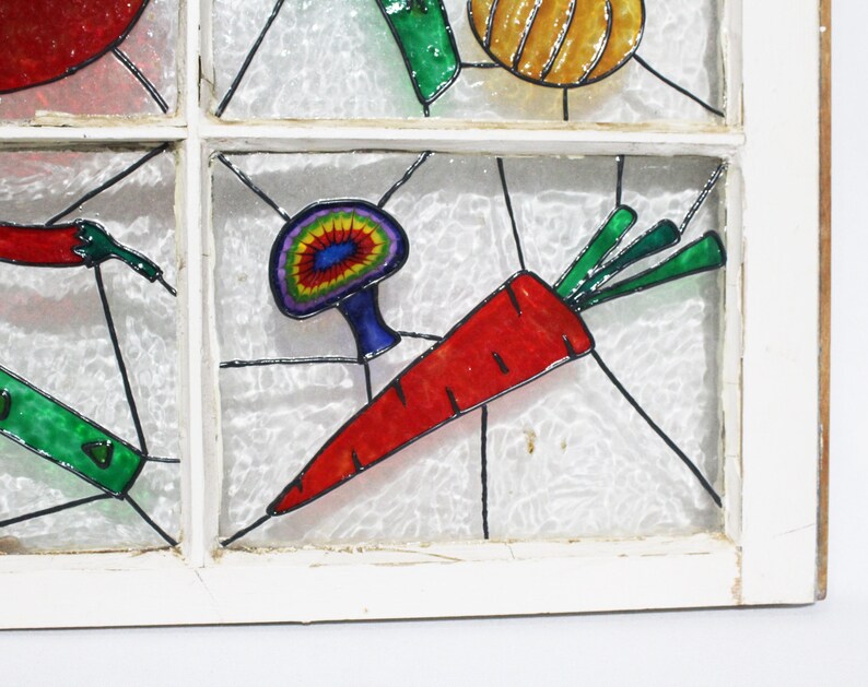 May include: A stained glass window featuring a colourful carrot, mushroom, and other vegetables painted on it.