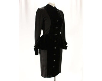 May include: A black velvet dress with a peplum waist and a row of buttons down the front.