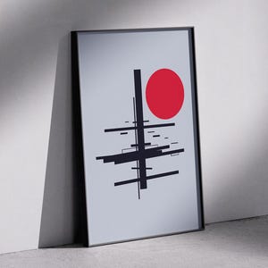 May include: A black and white abstract geometric design with a red circle in the center, framed in a black frame.