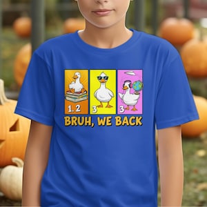 おもしろい新学期用ダックシャツ、We Back Kids & Teacher Tシャツ、漫画風ダックグラフィックTシャツ、新学期の服装