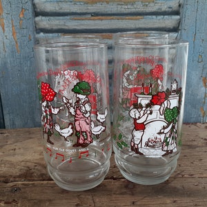 May include: Two clear glass tumblers with red, green, and white illustrations of the Twelve Days of Christmas. The tumblers feature the text "Twelve Days of Christmas" and "Two Turtle Doves and a Partridge in a Pear Tree".
