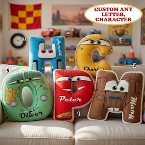 May include: Five plush letter-shaped pillows featuring character designs. The blue H says Harold, yellow C says Charlotte, green O says Oliver, red P says Peter with 95, and brown M says Marty. Each pillow has cartoon eyes and a mouth.