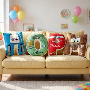 May include: Four plush letter-shaped pillows arranged to spell HOPE. The blue H features the name Harold, the green O features the name Oliver, the red P features the name Peter, and the brown E features the name Mark, all with cartoon faces.