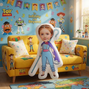 May include: A yellow sofa with Toy Story character designs and pillows. A large pillow featuring a girl in a Bo Peep costume is in front of the sofa. The wall is decorated with Toy Story themed decals and the text "To Infinity and Beyond".