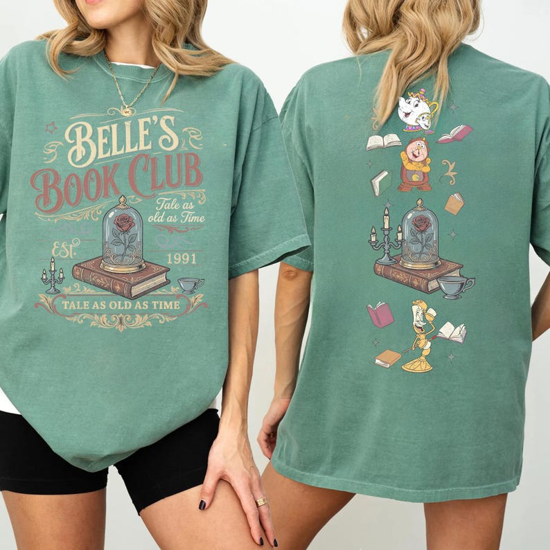 May include: Green t-shirt with "Belle's Book Club" graphic on the front, featuring a rose in a glass dome, books, and teacups. The back of the shirt has a similar design with animated characters and books. The text "Tale as old as Time" is also included.