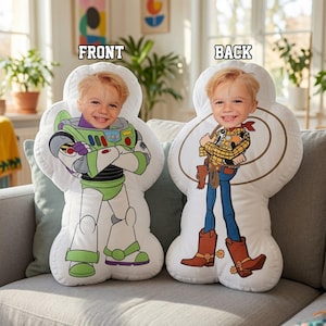 May include: Two custom-shaped pillows featuring a child's face. The left pillow shows a Buzz Lightyear character body, and the right pillow shows a Woody character body with a lasso. The text FRONT and BACK is printed above each pillow.