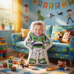 May include: A child's room decorated with Toy Story-themed items. A large Buzz Lightyear pillow with a child's face is in front of a blue sofa with Toy Story-themed pillows. Woody and Mr. Potato Head toys are on the floor, along with colorful blocks.