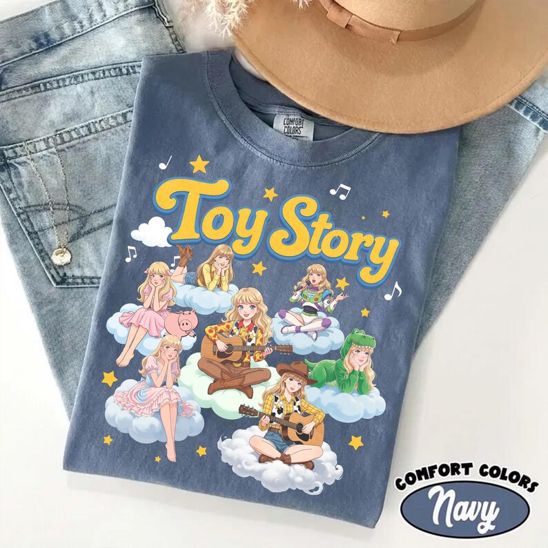 May include: A blue t-shirt featuring the text Toy Story in yellow letters. The graphic displays multiple anime-style characters dressed in costumes inspired by the film, each sitting on a white cloud, surrounded by yellow stars and musical notes.