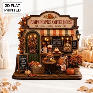 May include: A 2D flat printed miniature Pumpkin Spice Coffee House display featuring a green door, striped awning, and autumn decor. The sign reads Pumpkin Spice Coffee House, coffee, lattes, treats, and Pumpkin spice served here.
