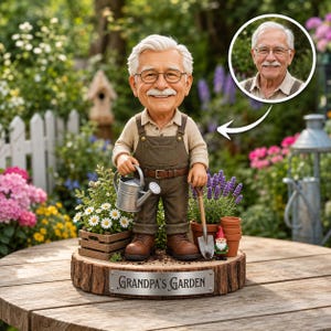 May include: A custom figurine of an older man with white hair and glasses wearing brown overalls, holding a silver watering can and a small shovel. The figure stands on a wooden base with a metal plaque reading "Grandpa's Garden" and includes a small garden gnome.