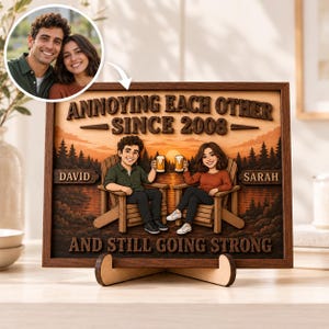 May include: A rectangular wooden sign featuring a cartoon illustration of a couple sitting in chairs, holding beer mugs, with a sunset forest background. The text reads: ANNOYING EACH OTHER SINCE 2008, DAVID, SARAH, AND STILL GOING STRONG.