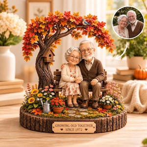 May include: A decorative figurine of an elderly couple sitting on a bench under a tree with autumn leaves. The base features a plaque reading "GROWING OLD TOGETHER SINCE 1972". The scene includes a birdhouse, flowers, and a small watering can.