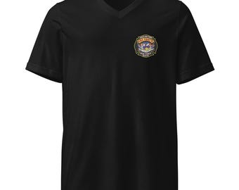 May include: Black V-neck t-shirt with a small, colorful emblem on the left chest. The emblem features text that reads "Highland Park Firefighters Task Force Rescue". The shirt is made of a soft material.