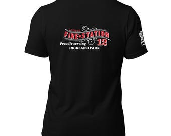 May include: Black t-shirt with the words "Fire Station 12" in red and white, with the text "Proudly serving Highland Park." A small graphic is on the sleeve. The shirt is made of a soft material.