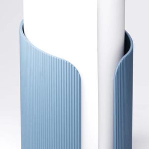 May include: A pale blue paper towel holder with a vertical ribbed pattern. The holder has curved sides, and a white paper towel roll is visible inside.