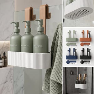 May include: A white, ribbed, oval-shaped shower caddy with two wooden hooks for hanging over a glass partition. It holds three matte sage green pump bottles labelled CLEANSE, HYDRATE, and RESTORE. A sage green waffle-textured towel hangs nearby.