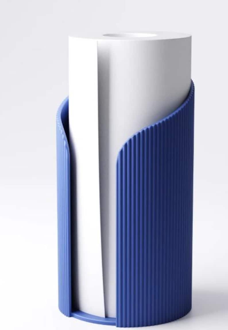May include: A white paper roll is held by a blue holder. The holder has a ribbed texture and a curved design that wraps around the paper roll. The holder is made of a solid, opaque material.