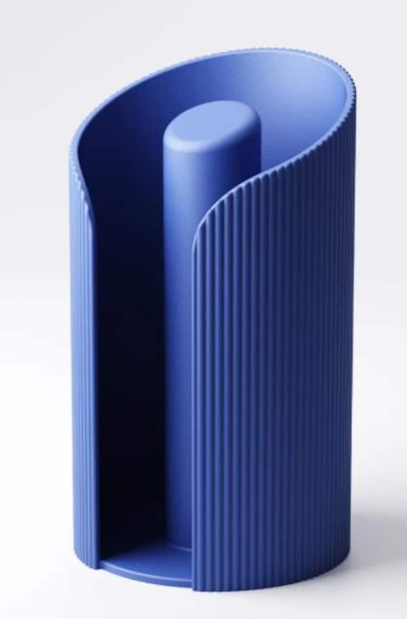 May include: A modern, blue cylindrical object with a central column and curved, ribbed sides. The design features a solid base and a smooth, rounded top, creating a minimalist aesthetic. The object is approximately 25 cm tall.
