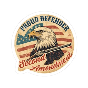 May include: A sticker featuring a bald eagle with a shotgun, set against a distressed American flag. The text reads "Proud Defender" and "Second Amendment" in a vintage style.