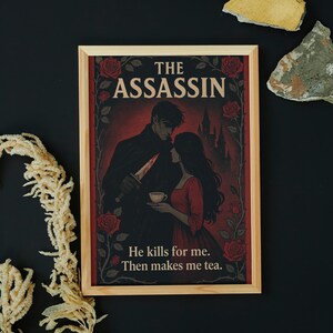 May include: Framed print featuring a romantic illustration with the text "THE ASSASSIN." The artwork depicts a man holding a knife and a woman holding a teacup, with the words "He kills for me. Then makes me tea."