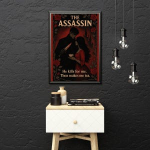 May include: Framed art print featuring a romantic illustration with the text "THE ASSASSIN." The image depicts a man holding a knife and a woman holding a teacup, with the text "He kills for me. Then makes me tea." Red roses frame the artwork.